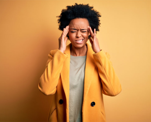 Woman suffering from Migraine